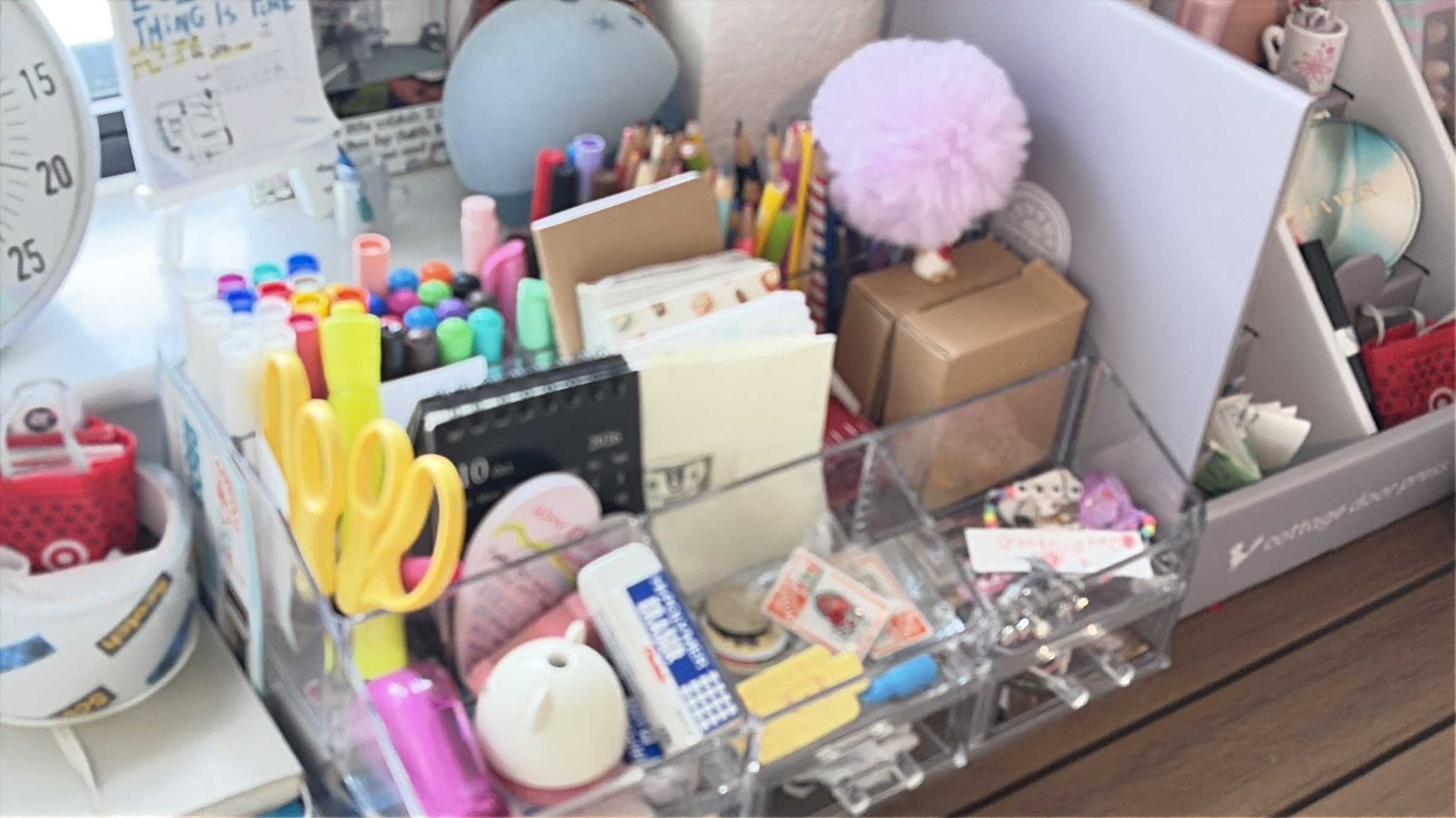 Stationery grouped in compartments of a desk organizer