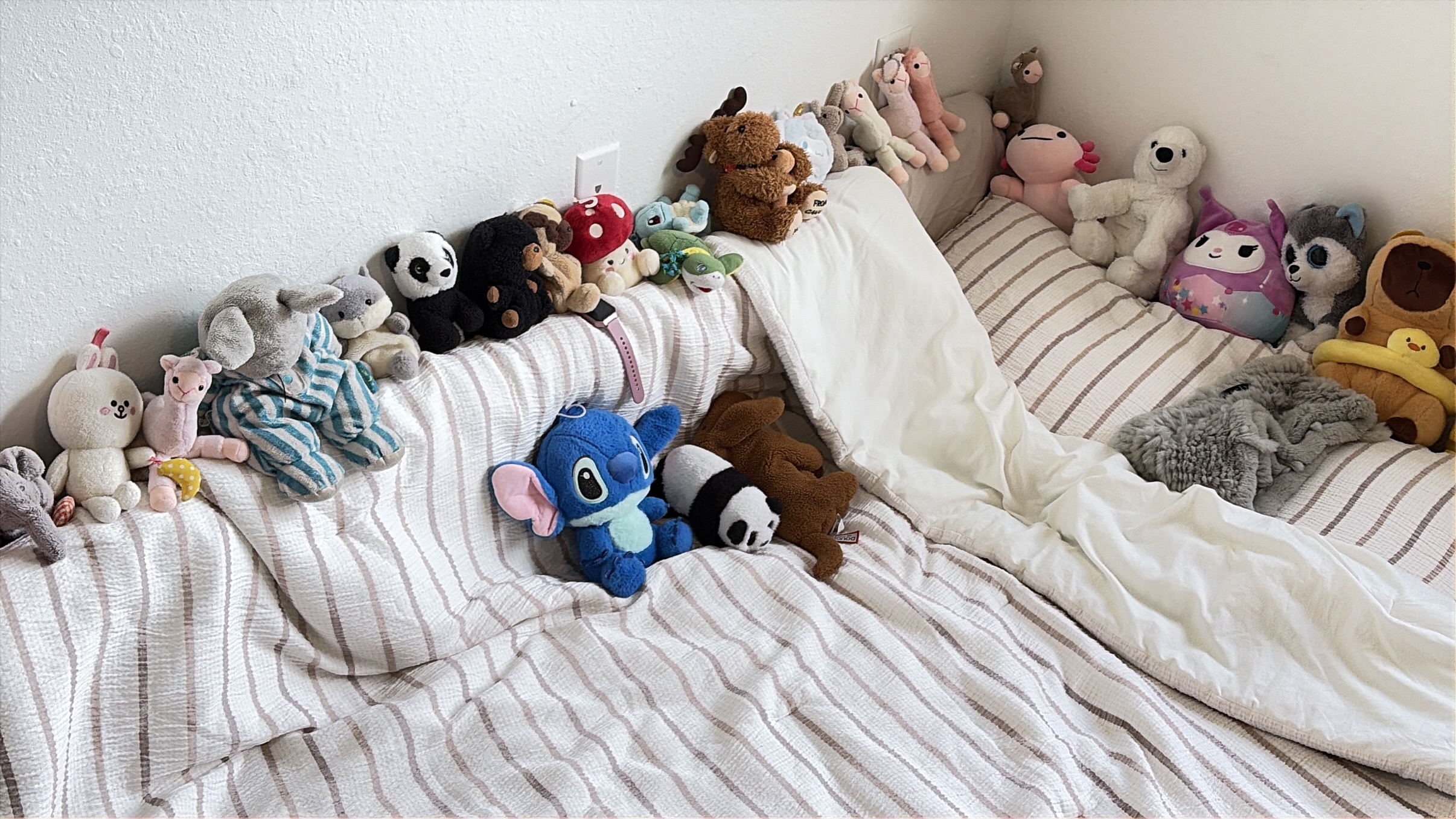 Stuffed animals arranged together on a sofa